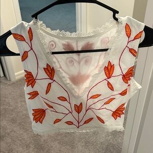 WaiMari Sleeveless Blouse with Orange Floral Design